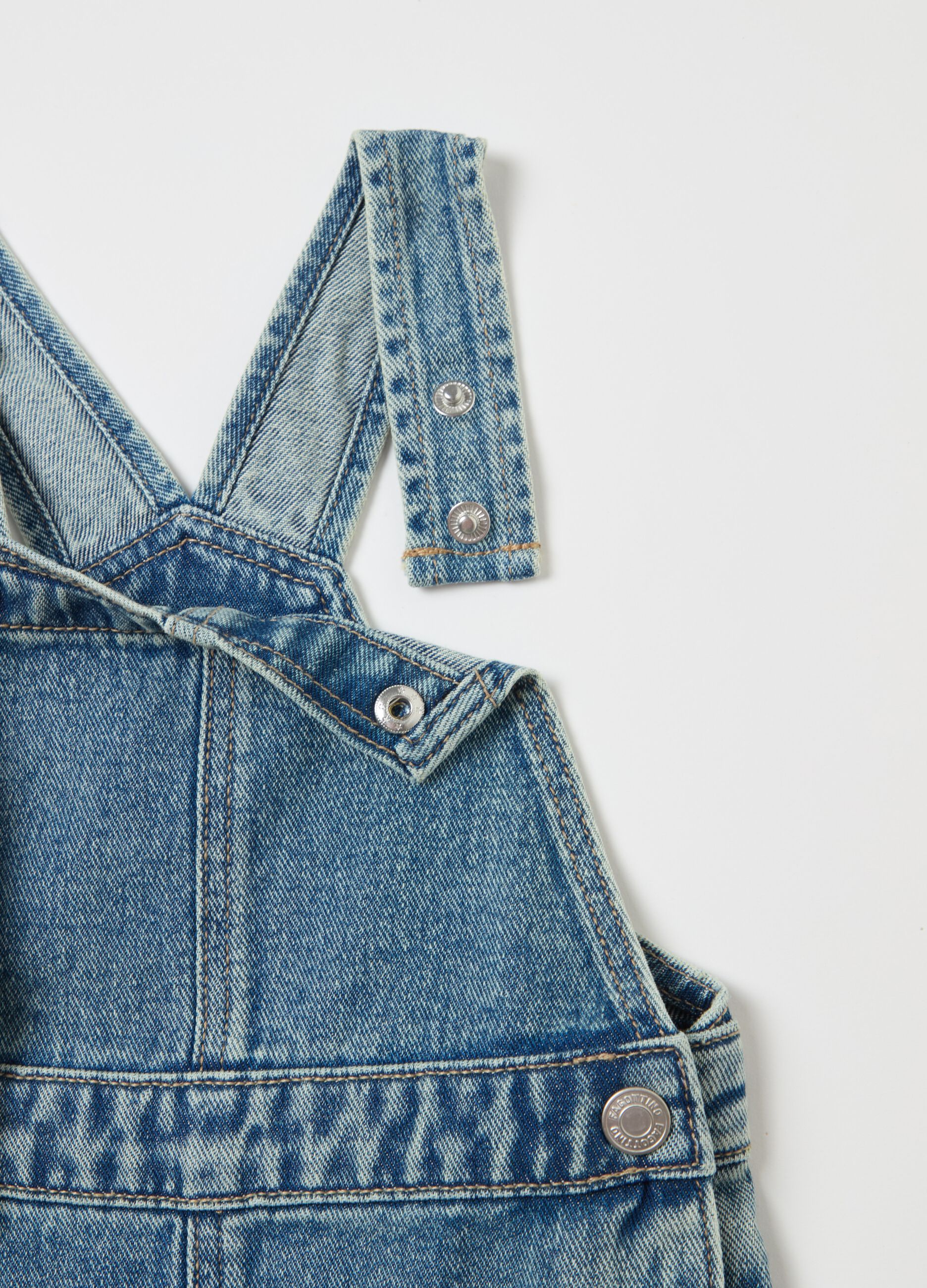 Denim dungarees with abrasions