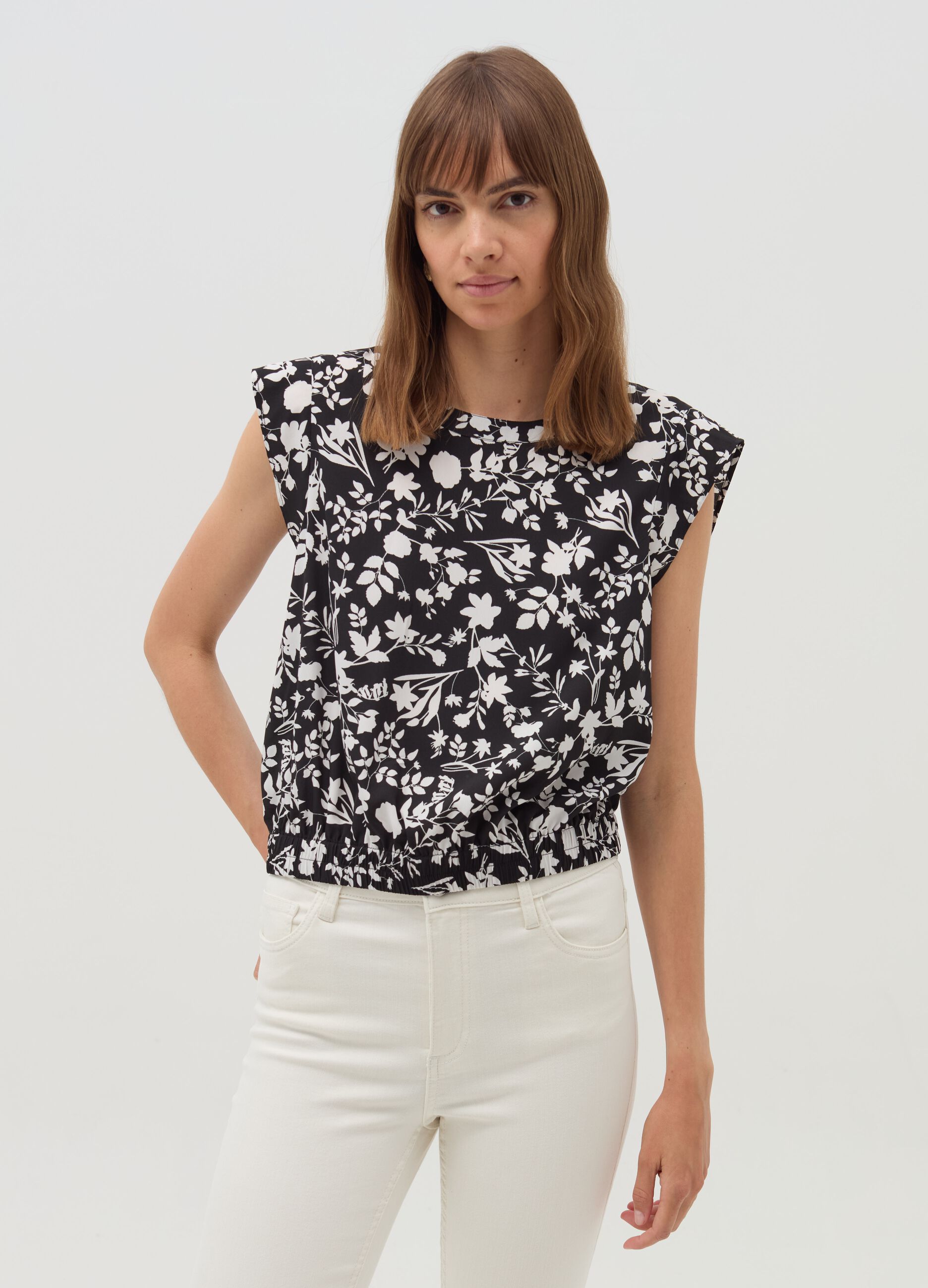 Sleeveless blouse with patterned flounce