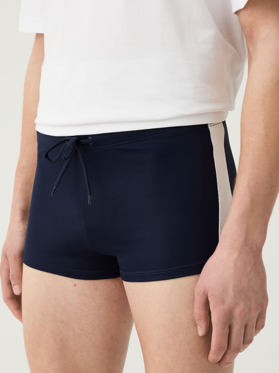 Swimming trunks with side bands_1